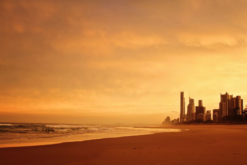 Stunning sunset view of Surfers Paradise beach with city skyline in Gold Coast, Australia.
