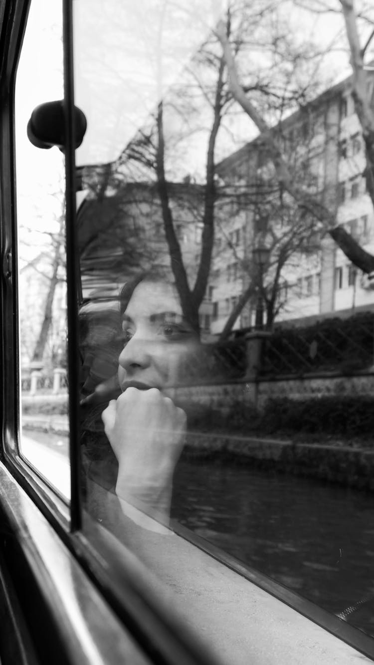 Woman Face Reflection In Window