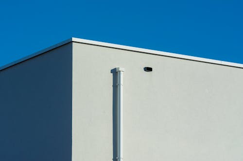 A white building with a blue sky in the background