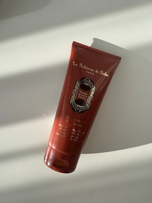 A tube of body lotion on a white surface