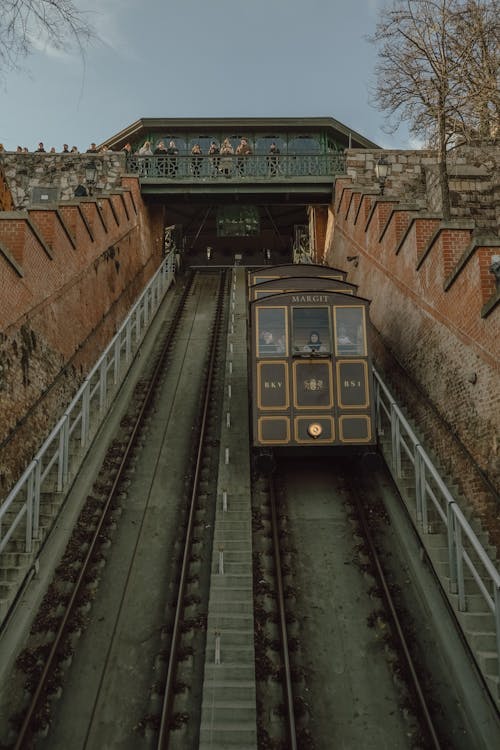 A train traveling through a tunnel with a brick wall