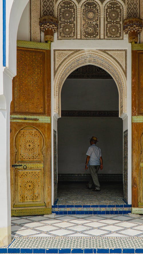 A man walking through a doorway in a mosque