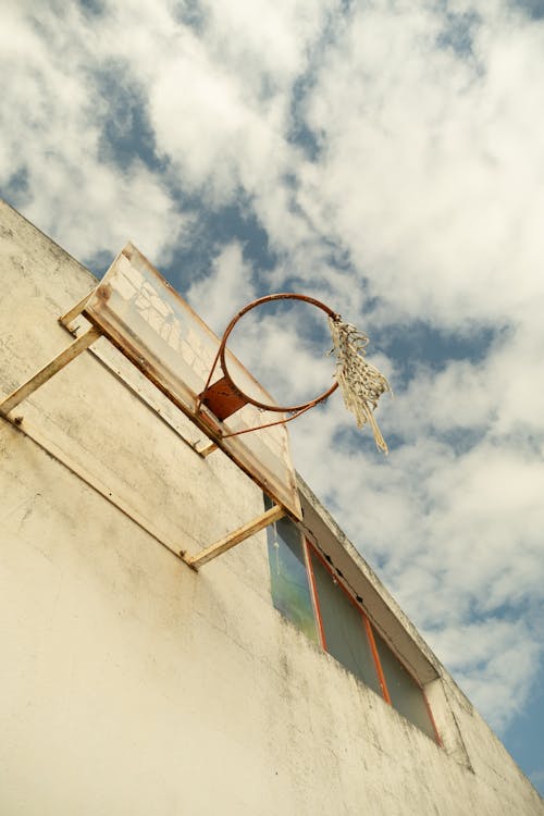 A basketball hoop is hanging from a building