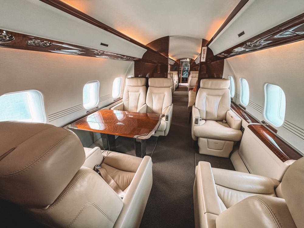 Private jet cabin with leather seats and wood detailing