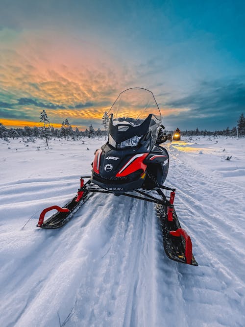 A snowmobile is parked on the side of the road