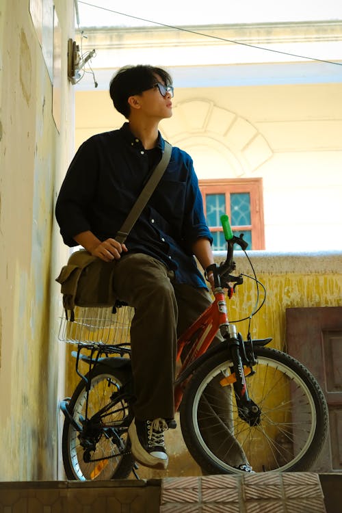 A man is sitting on a bike
