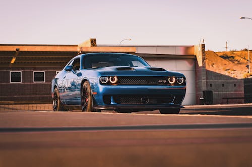 A blue dodge challenger parked on the street