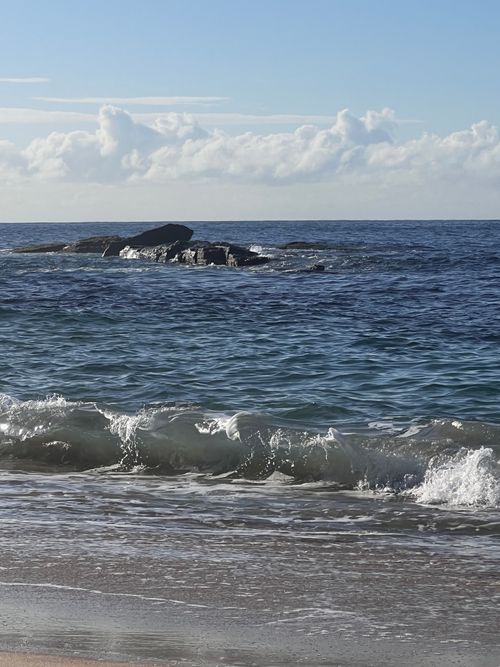 Free Calm ocean waves and rocky shoreline at Coogee Beach, NSW, Australia. Stock Photo