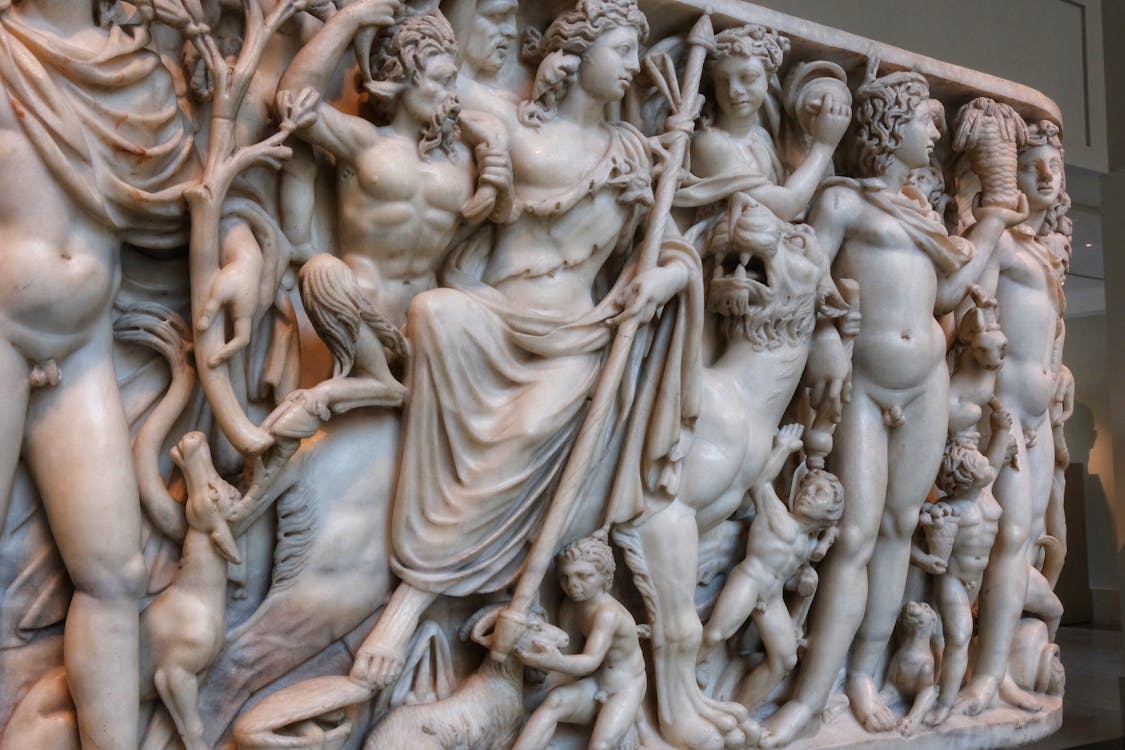Free A marble sculpture depicting a group of people Stock Photo
