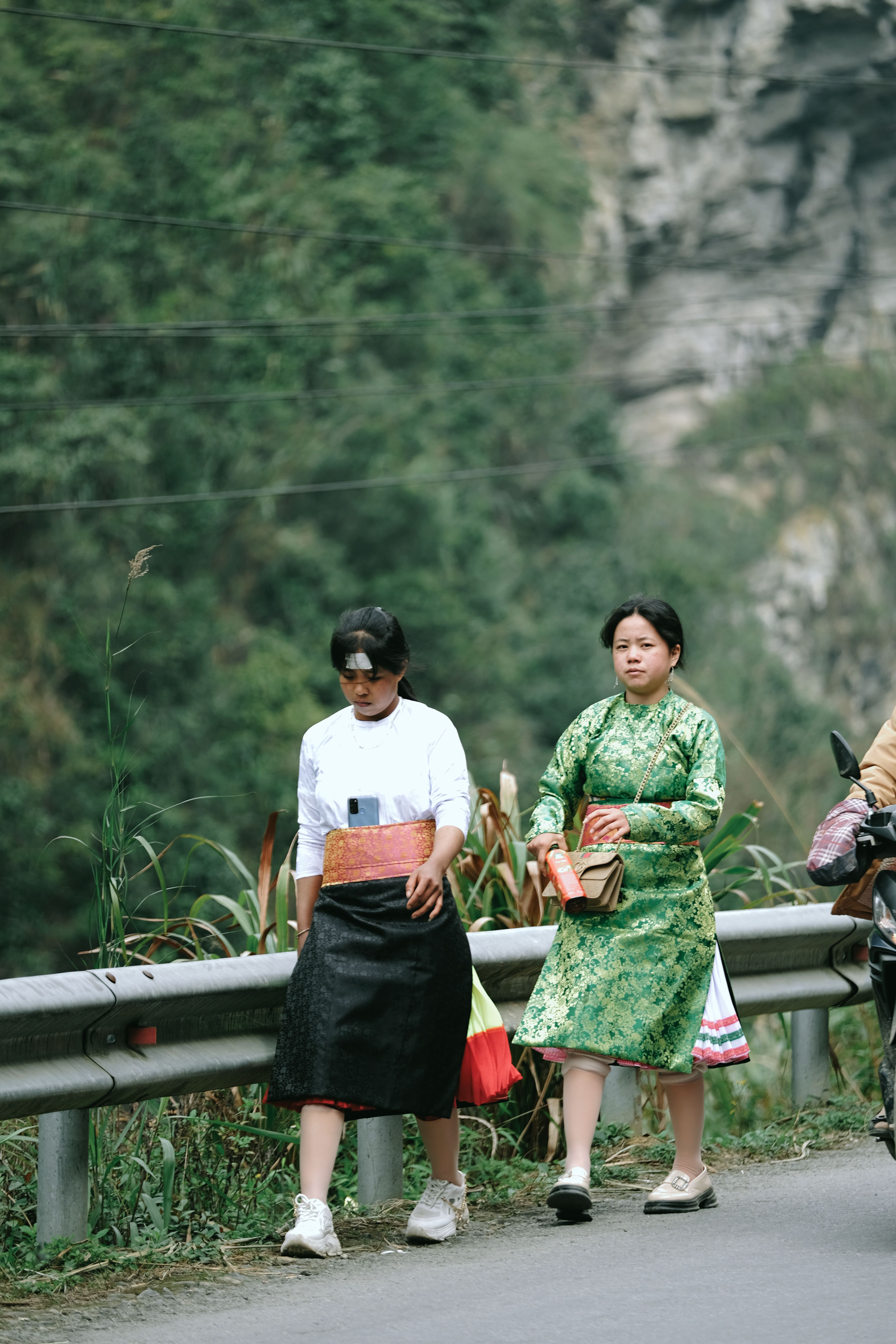 Two Young Women Walking along a Country Road · Free Stock Photo