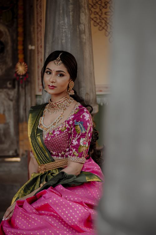 Free Portrait of a young South Asian woman in a vibrant pink sari with ornate jewelry, exuding grace. Stock Photo