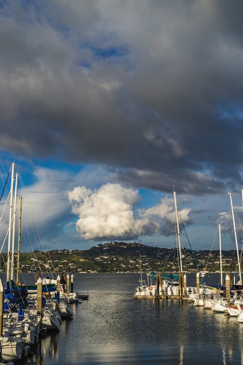 A marina with boats docked under a cloudy sky