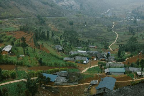 Free Idyllic countryside village nestled in terraced fields, showcasing rustic charm. Stock Photo