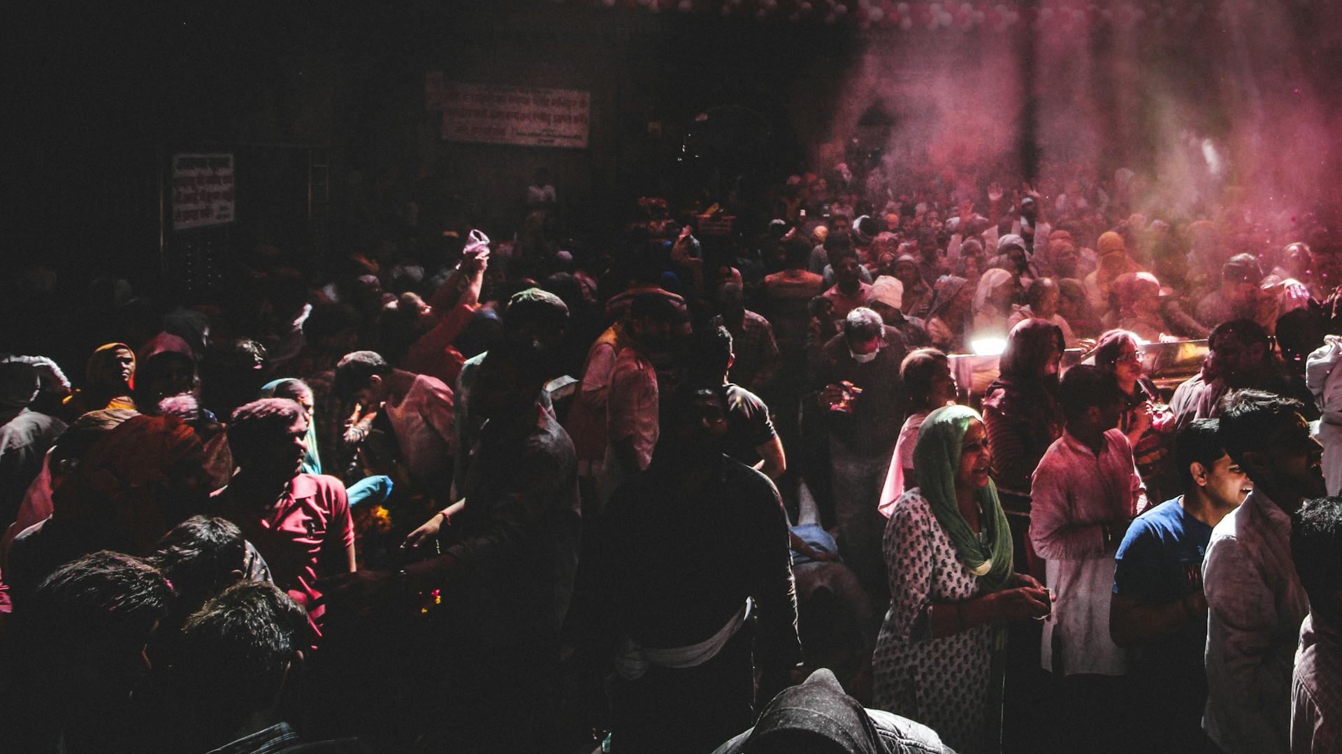 A lively crowd celebrates Holi, the festival of colors, in India with vibrant energy.