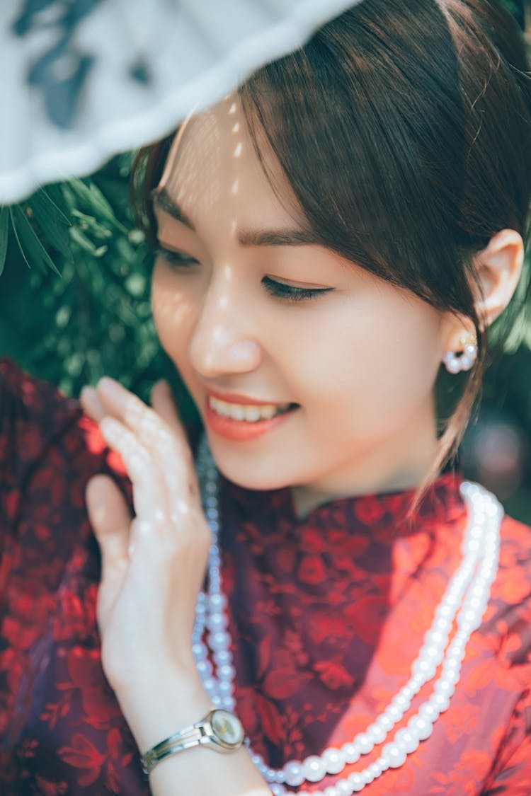 Smiling Young Woman In Pearl Necklace And Earrings