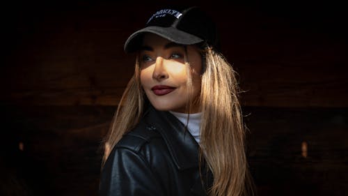A woman in a leather jacket and hat
