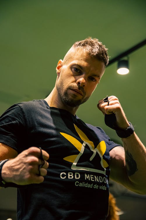 Man in T-shirt Standing with Fists Raised