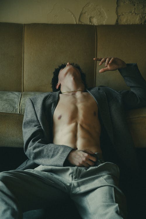 Shirtless Man Posing in a Gray Blazer and Pants