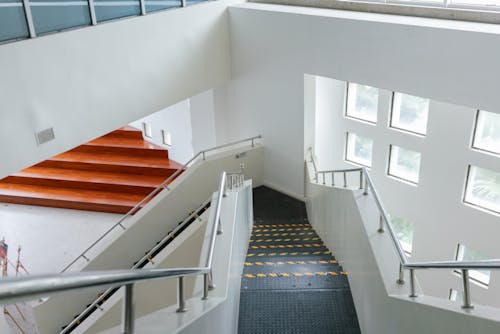 A stairway with a glass railing and stairs