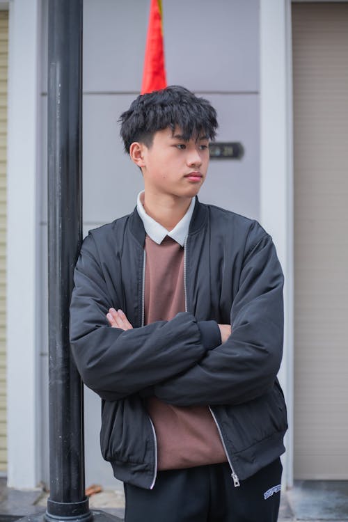 A young man standing on a street corner