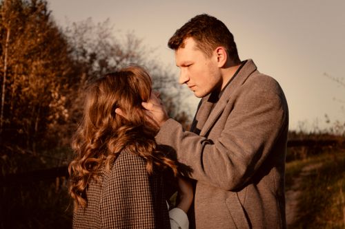 Free A romantic moment between a couple posing in coats during a fall afternoon in rural Lviv, Ukraine. Stock Photo