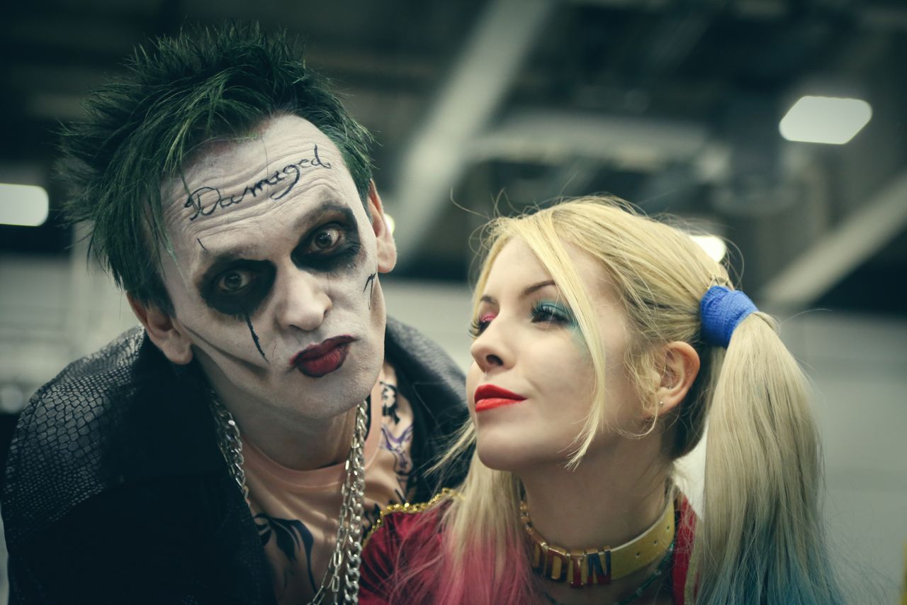 a couple in detailed halloween cosplay with striking makeup and costum