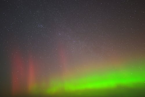 The aurora bore is seen in the sky over the ocean