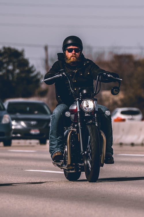 Free Man Riding Motorcycle on Highway Stock Photo