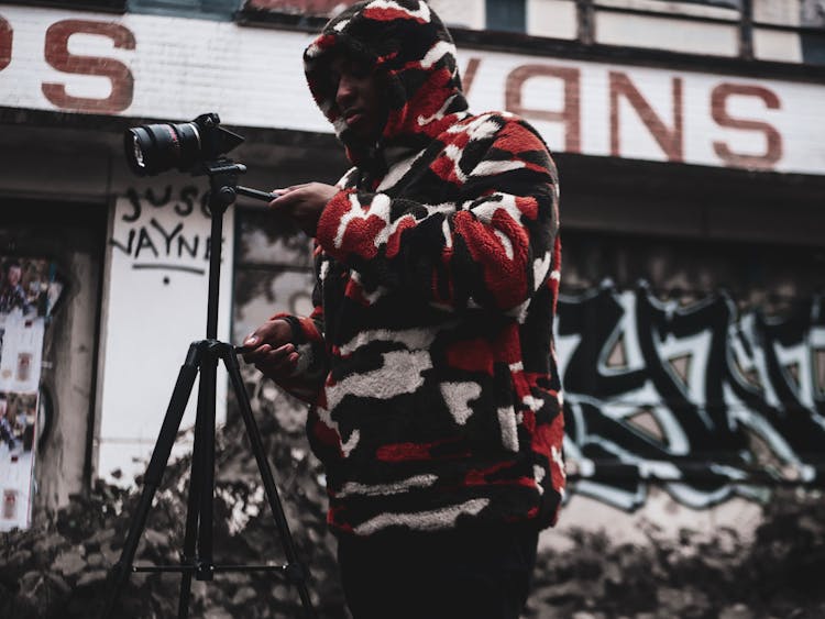 Man Standing Holding Camera