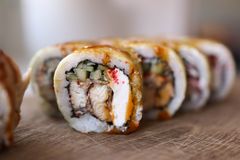 Row of sushi rolls, photo by Valeria Boltneva on Pexels