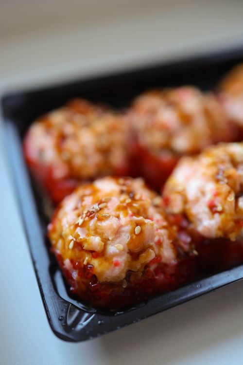 Free Mouthwatering close-up of takoyaki balls drizzled with savory sauce, perfect for food enthusiasts. Stock Photo