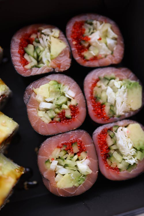 Sushi rolls with avocado and other ingredients in a black box