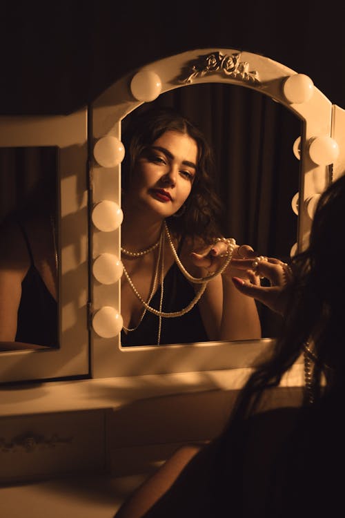 A woman looking in a mirror at her reflection