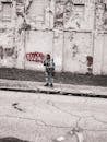 Man Standing in Front of Red Graffiti
