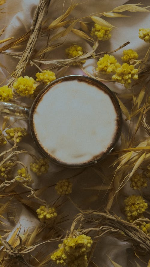 Yellow Flowers around White Foam in Glass