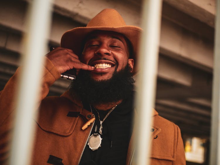 Photo Of Man Smiling Holding Cellphone