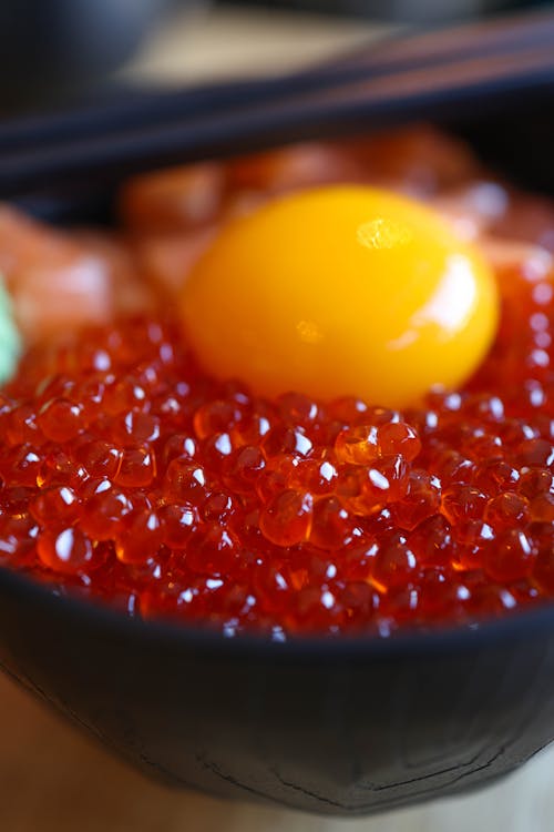 A bowl of red cavia with an egg