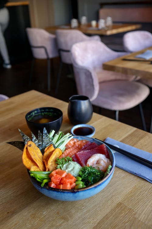 A bowl of sushi sits on a table