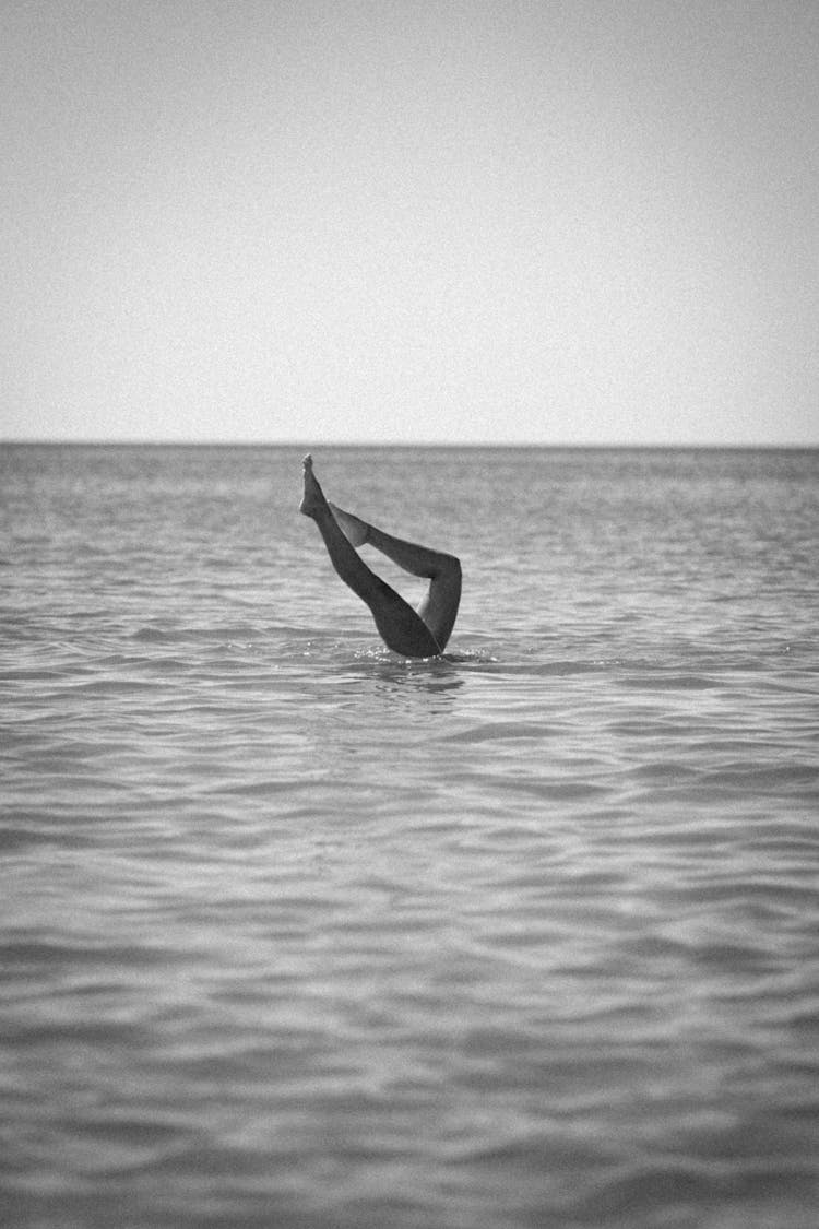 Legs Of Swimming Person On Sea Shore