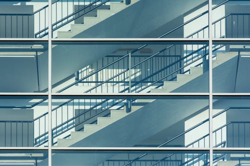 A glass wall with stairs and a railing