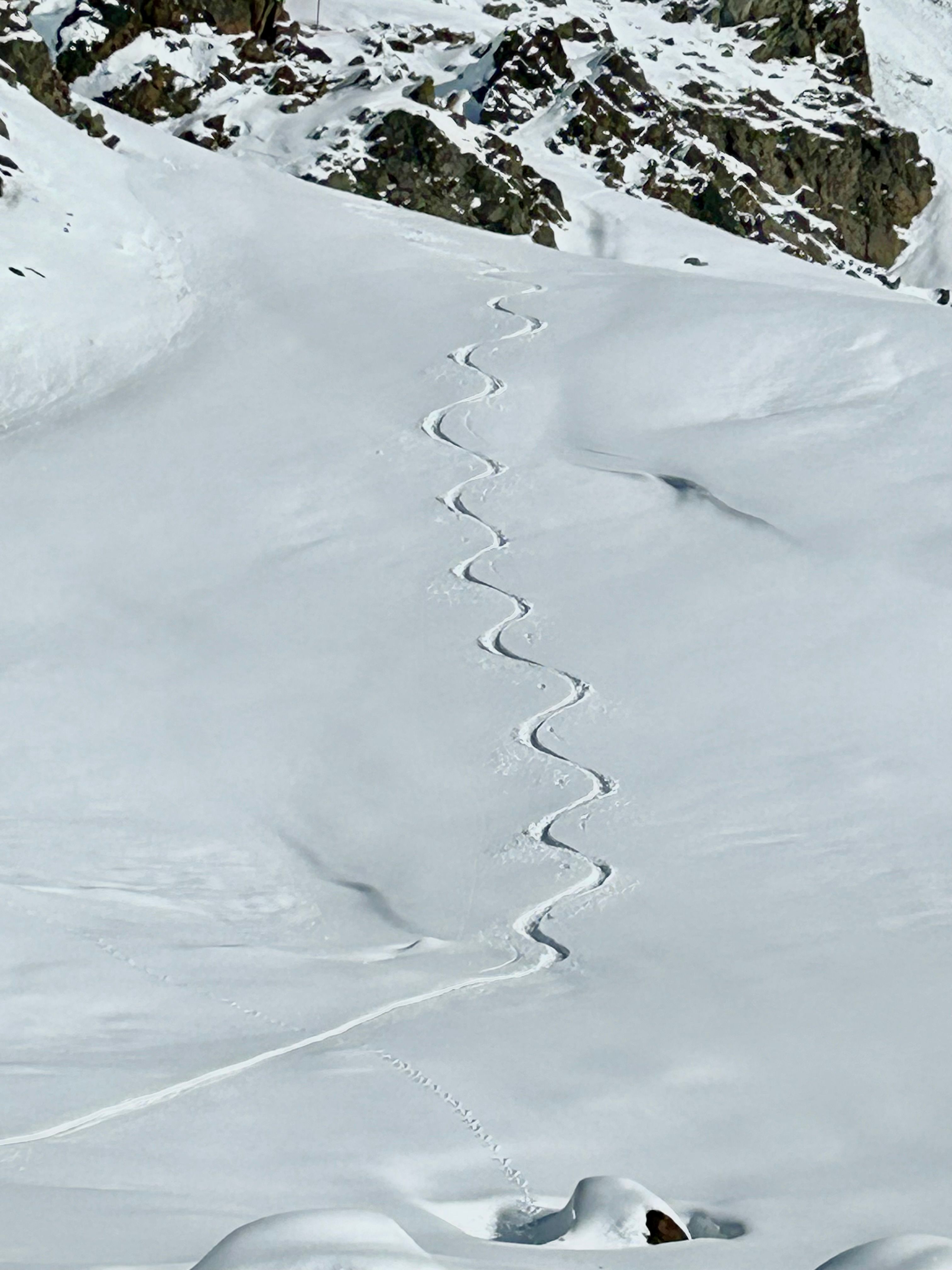 Aerial View of a Winding Trail in Snow in Mountains · Free Stock Photo