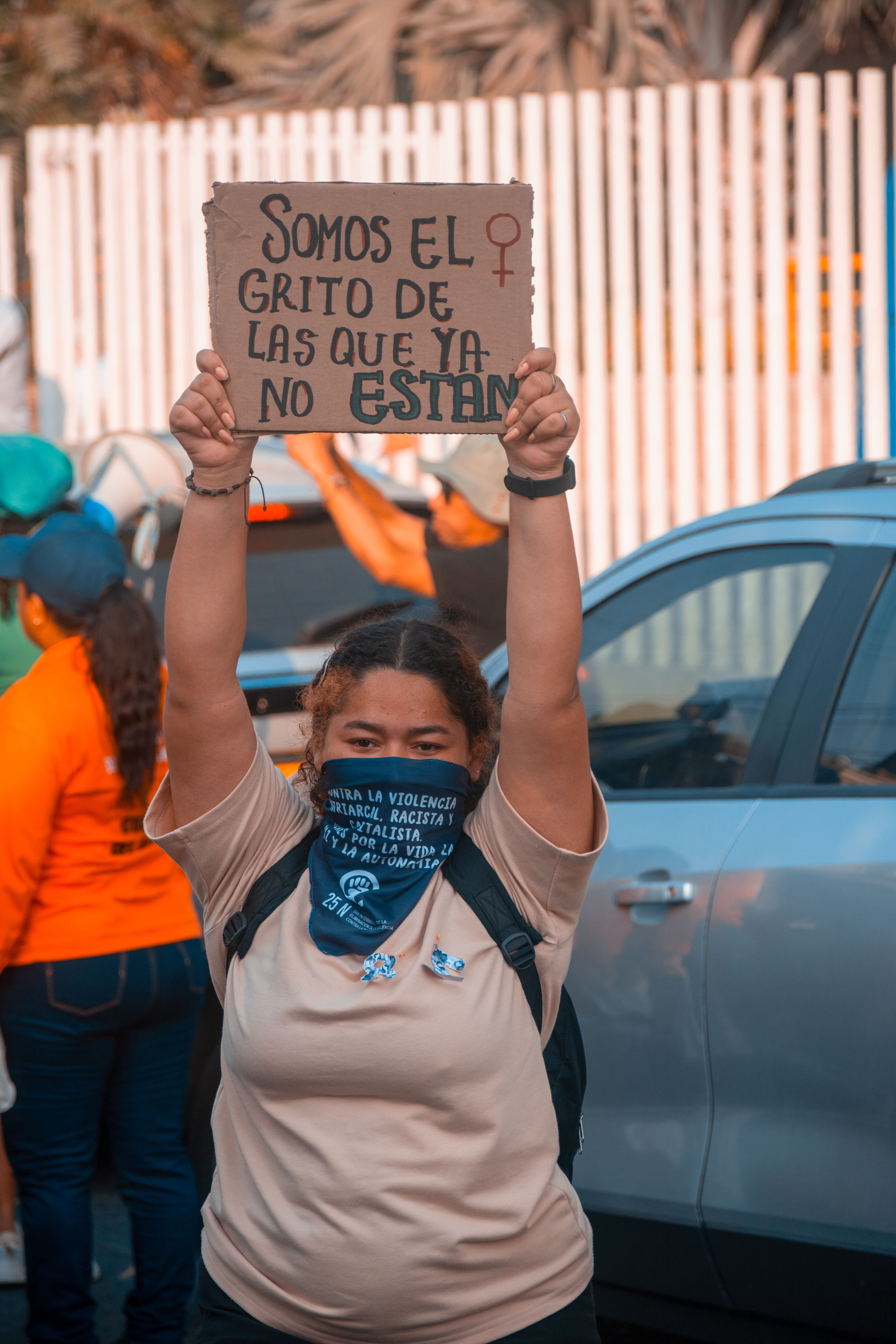 A Woman Holding a Sign at a Protest · Free Stock Photo