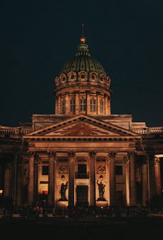 Stunning night view of illuminated Kazan Cathedral showcasing architectural elegance in St. Petersburg, Russia.