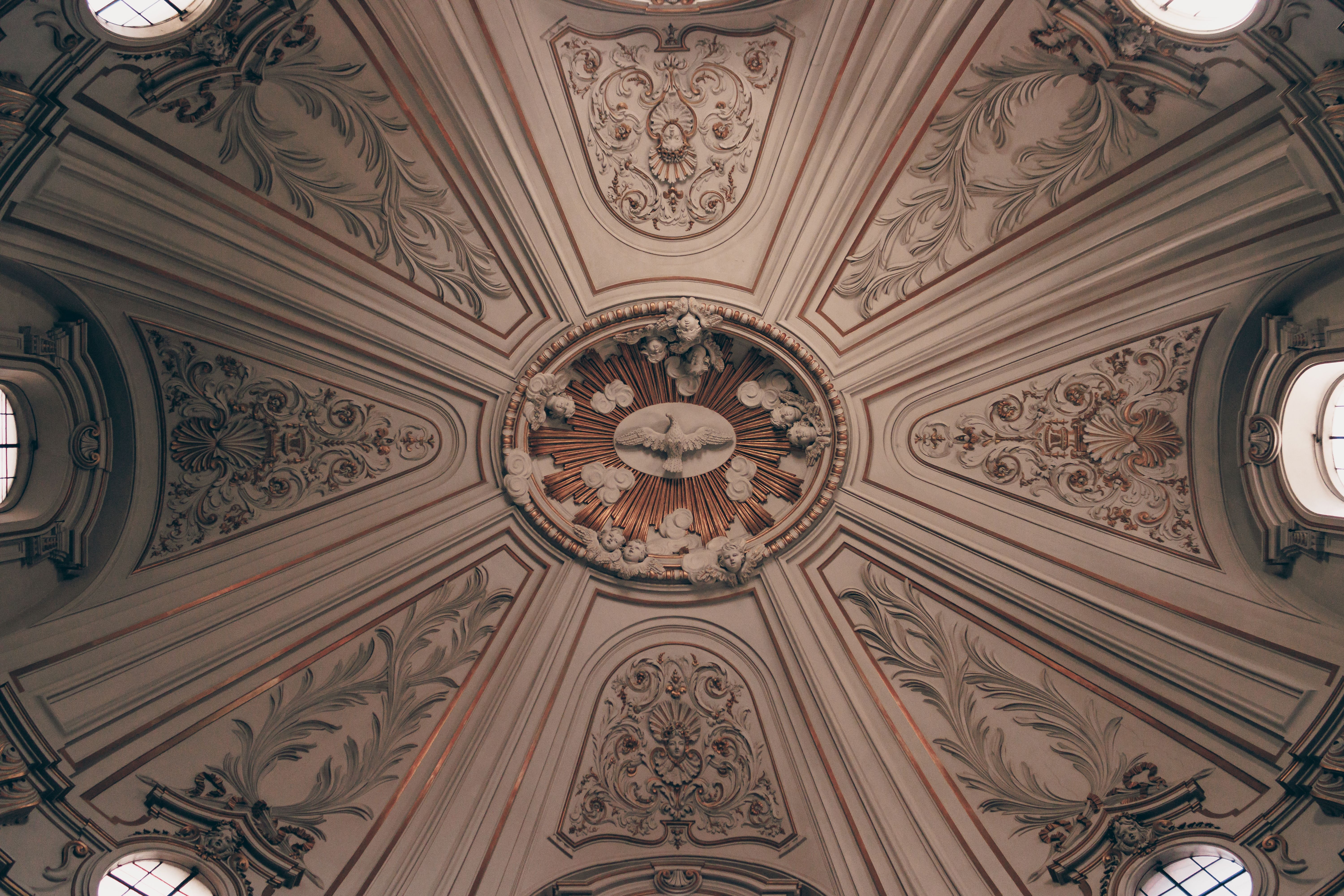 Ornate baroque ceiling design inside Santi Celso e Giuliano church, Rome, Italy.