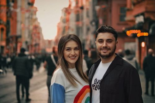 Free A joyful couple smiling brightly against the backdrop of a vibrant urban street. Stock Photo