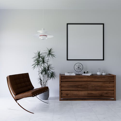 A white room with a wooden chair and a picture frame