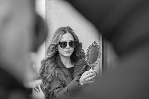 Woman in Jacket Holding Mirror