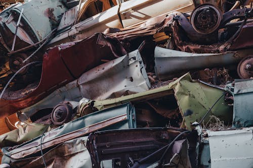 A pile of old cars in a junkyard