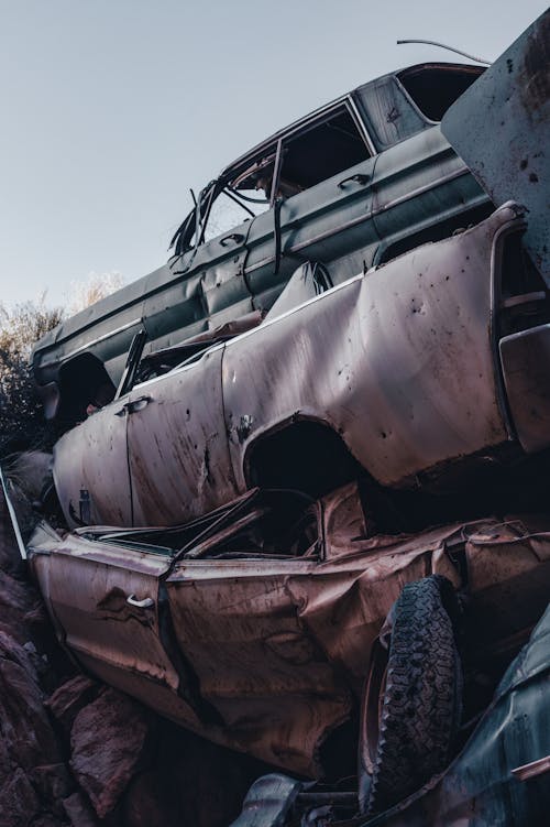 A pile of old cars in the desert