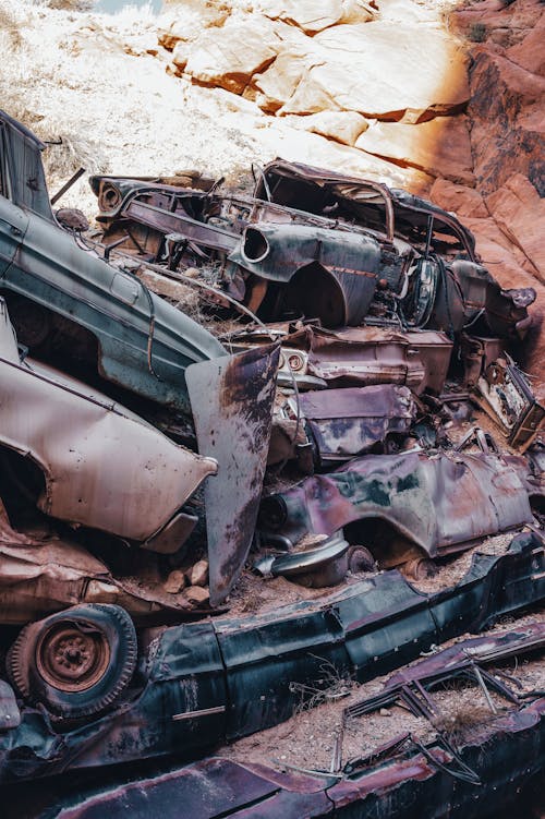 A pile of old cars in the desert